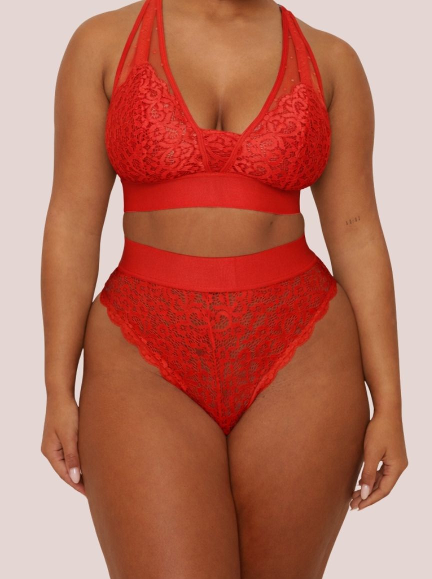 Red lace lingerie set on a plain background